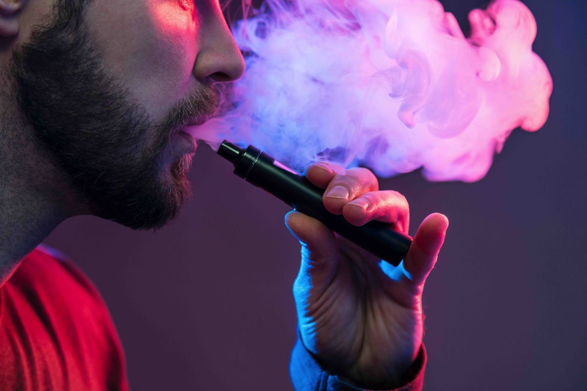 vaping flavored e liquid from an electronic cigarette image
